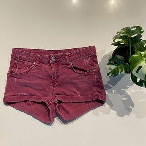 H&M maroon jean shorts with small rips, size 6.